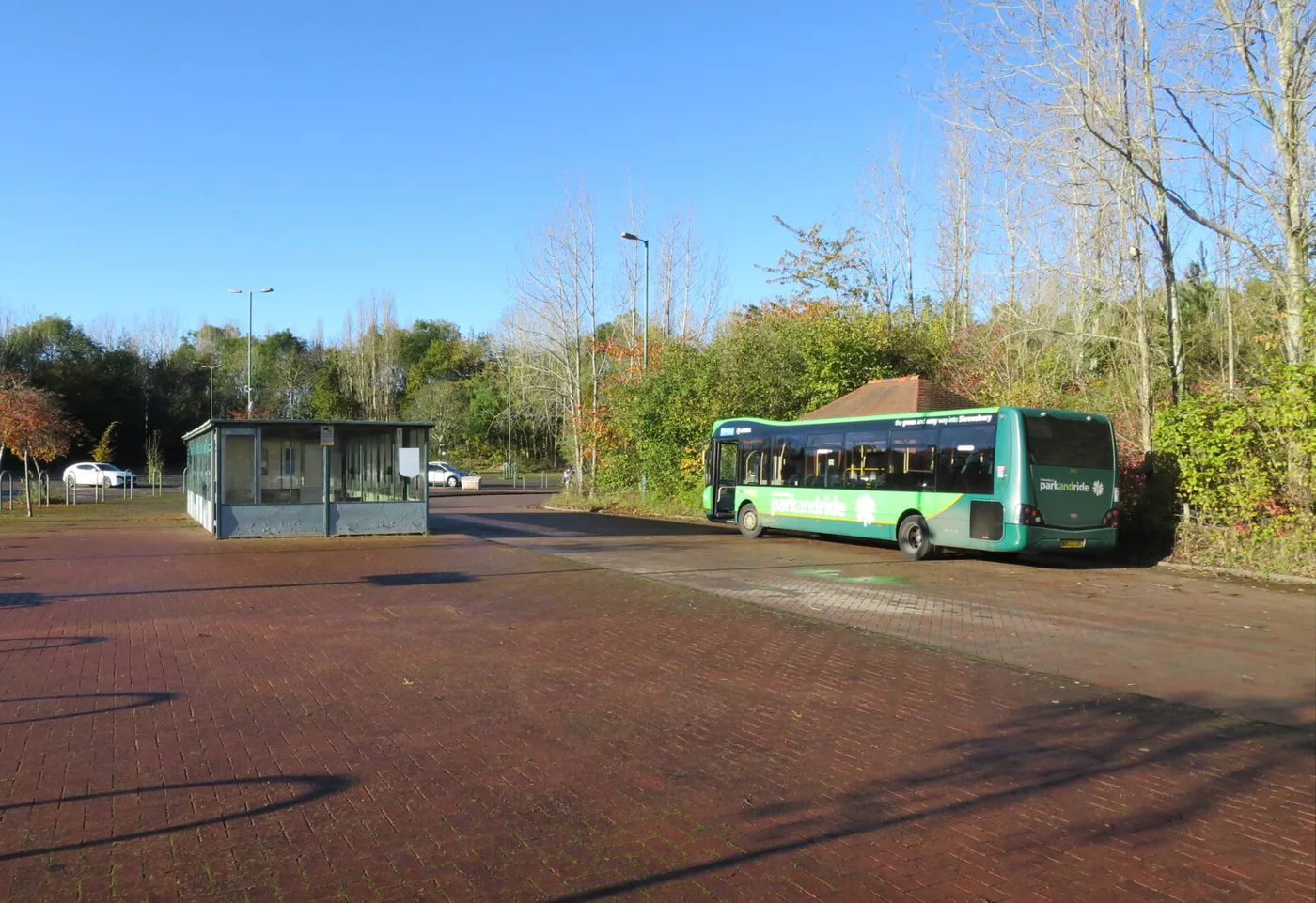 The Meole Brace Park and Ride site off Hereford Road, Shrewsbury, with a green Meole Brace bus at the stand, photographed in November 2023
